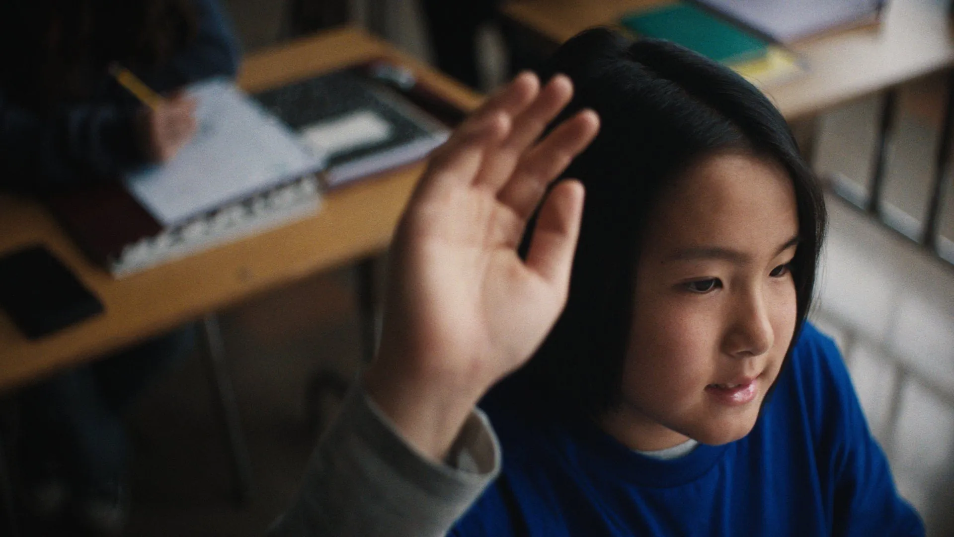 A hand goes up in class.